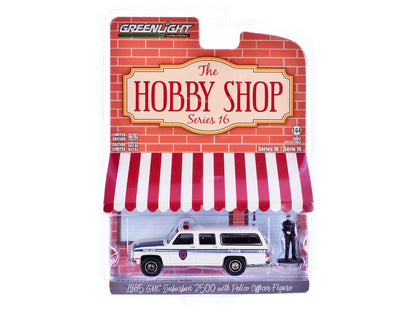 1985 GMC Suburban 2500 "New York City Transit Police Department" White with Blue Stripes and Police Officer Figure "The Hobby Shop" Series 16 1/64 Diecast Model Car by Greenlight-1